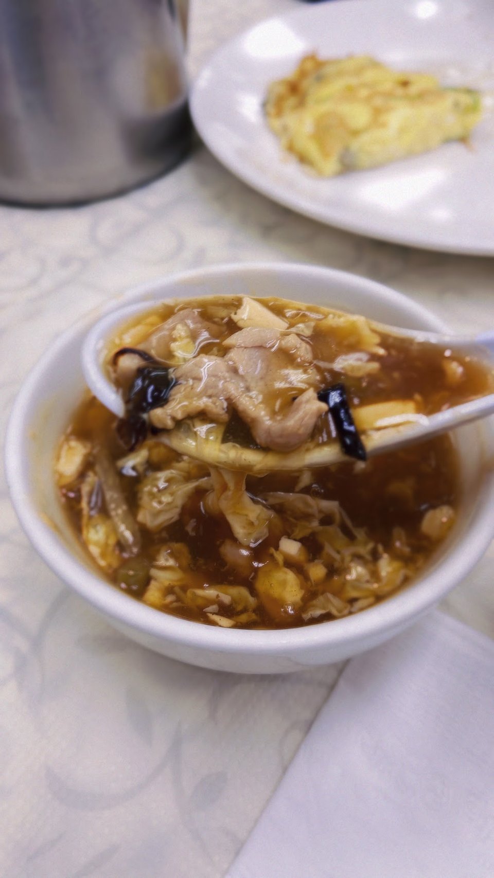 Printed menu with soups and noodle dishes.